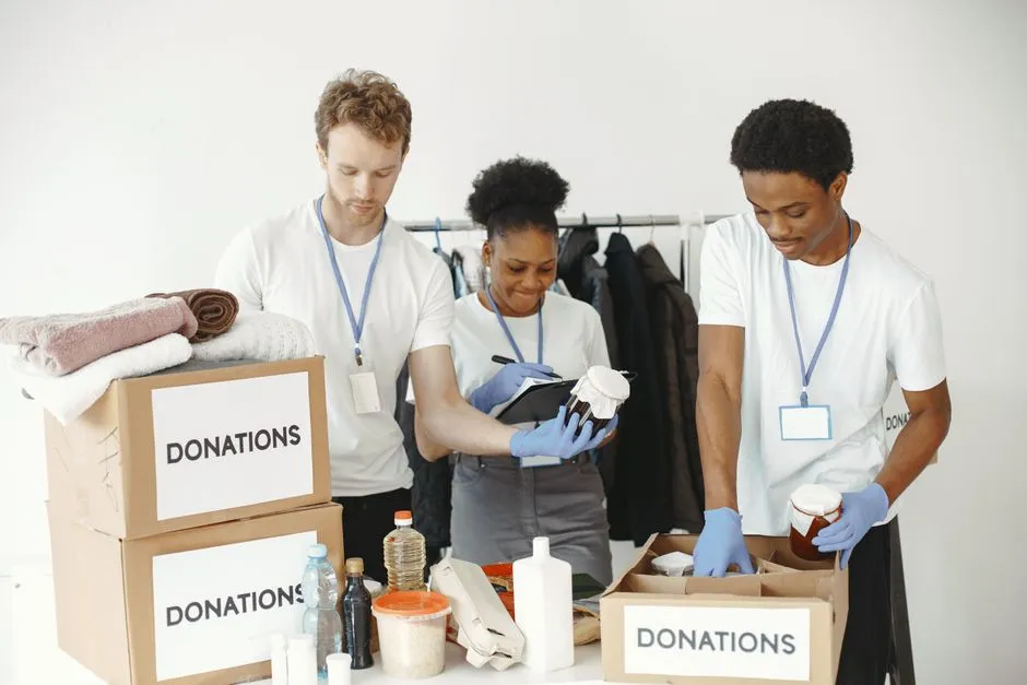 Volunteers packing boxes of donated food at a community distribution site